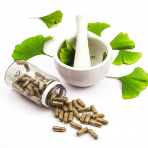 Promotional snapshot for an Alopecia & Beyond blog post from March 18, 2024, titled 'The Benefits Of Ginkgo Biloba For Hair'. The image features Ginkgo Biloba leaves, capsules spilled from a glass bottle, and a mortar and pestle, hinting at natural remedies for hair health.